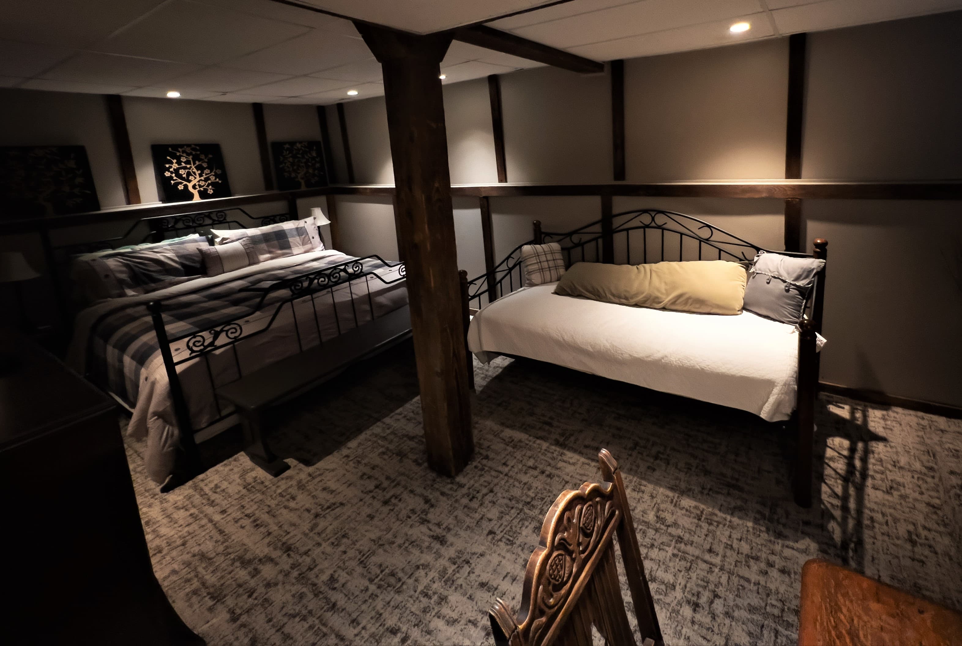 A warm, inviting bedroom with a king size iron bed and matching iron daybed