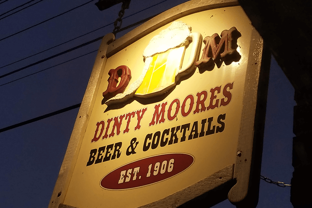 Sign for Dinty Moores Beer & Cocktails, established in 1906.