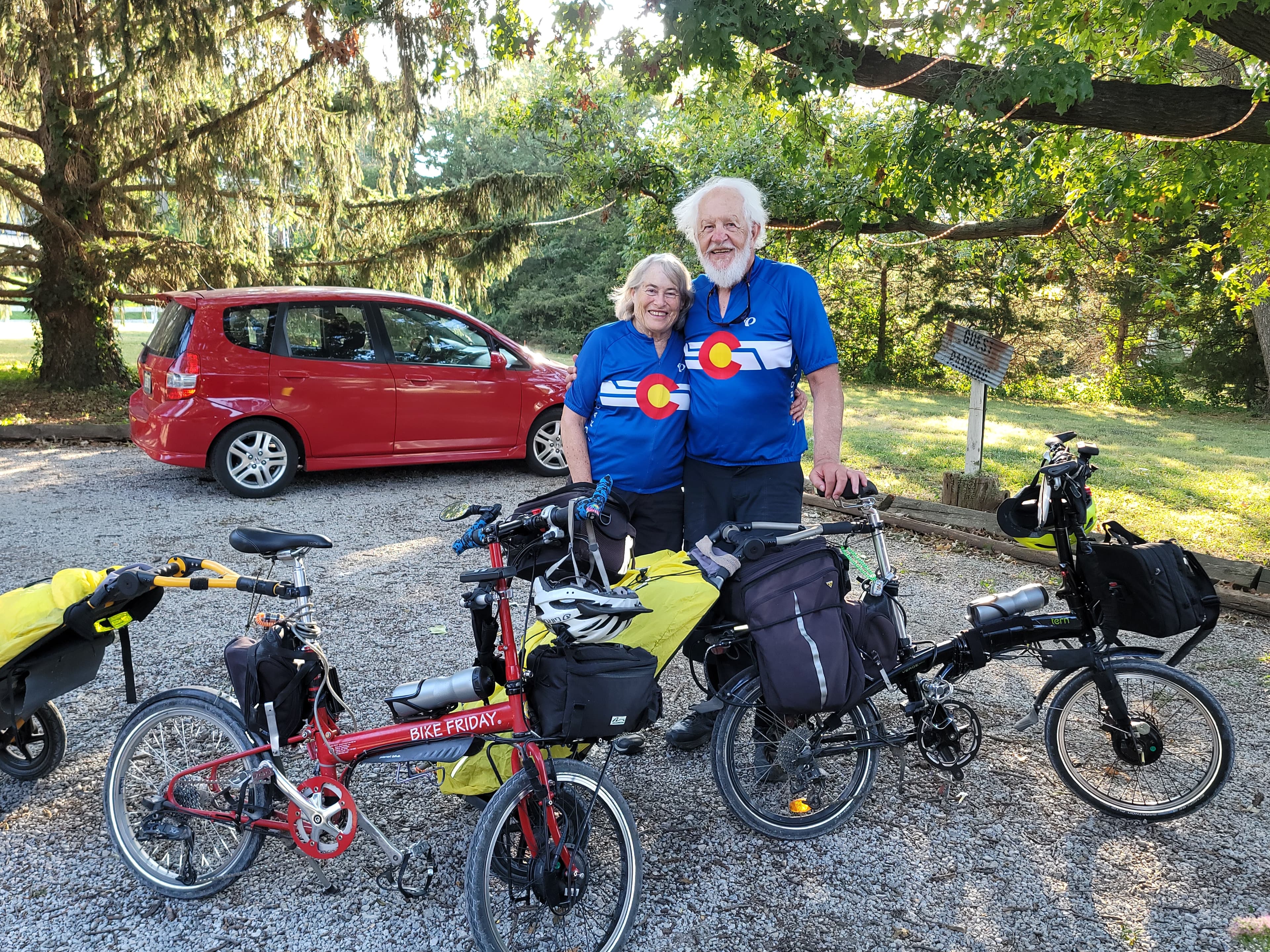 Bicycle touring couple with folding bikes and travel gear at Whispering Pines Bed & Breakfast in Nebraska City, Nebraska.