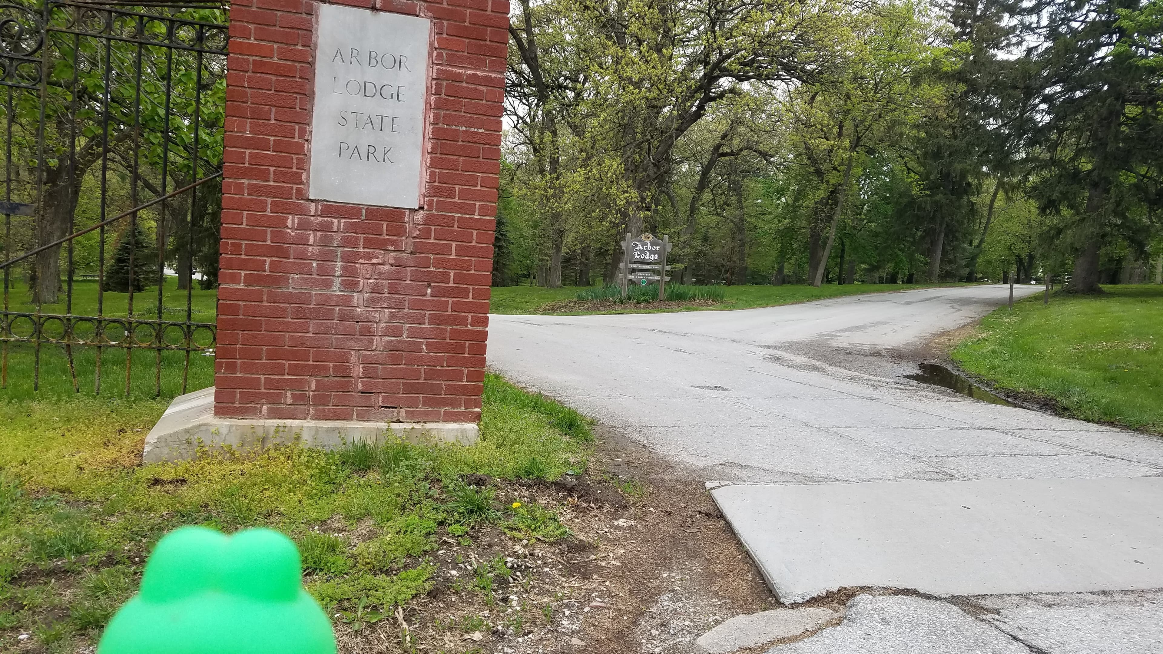 Froggy the bicycle mascot arrives at the entrance to Arbor Lodge State Historical Park in Nebraska City.