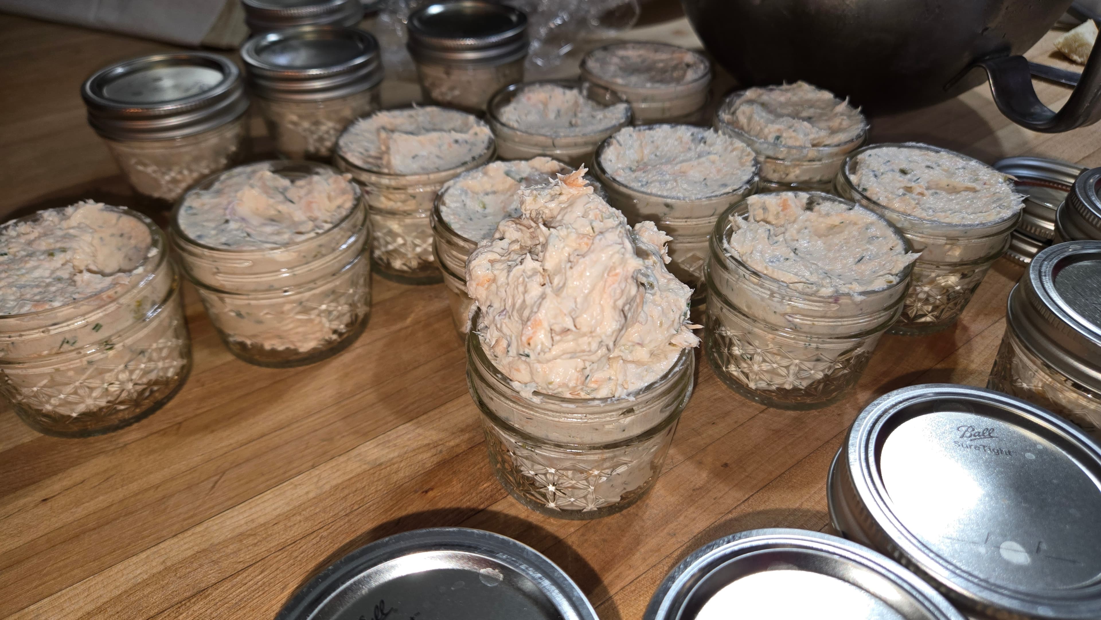 A collection of small jars filled with a creamy, light-colored mixture placed on a wooden surface.