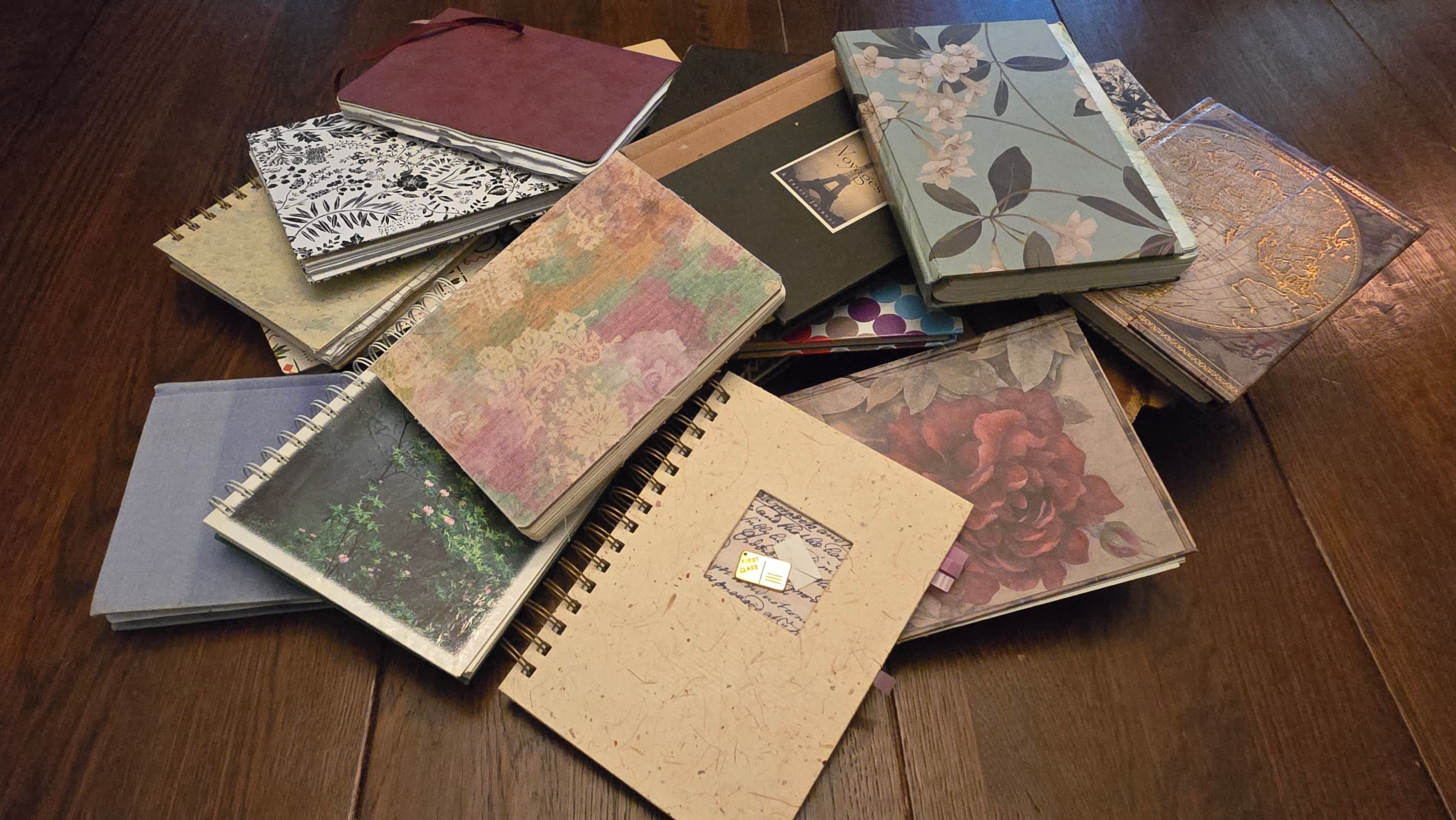 Seventeen guest journals piled on the dining room table at Whispering Pines Bed & Breakfast.