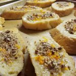 French Toast topped with butter, orange zest and pecans